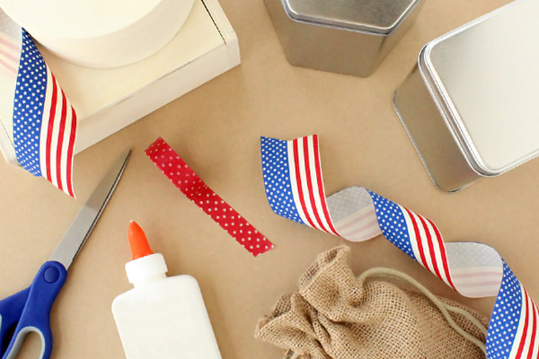 scissors, glue, boxes, and red, white, and blue ribbon