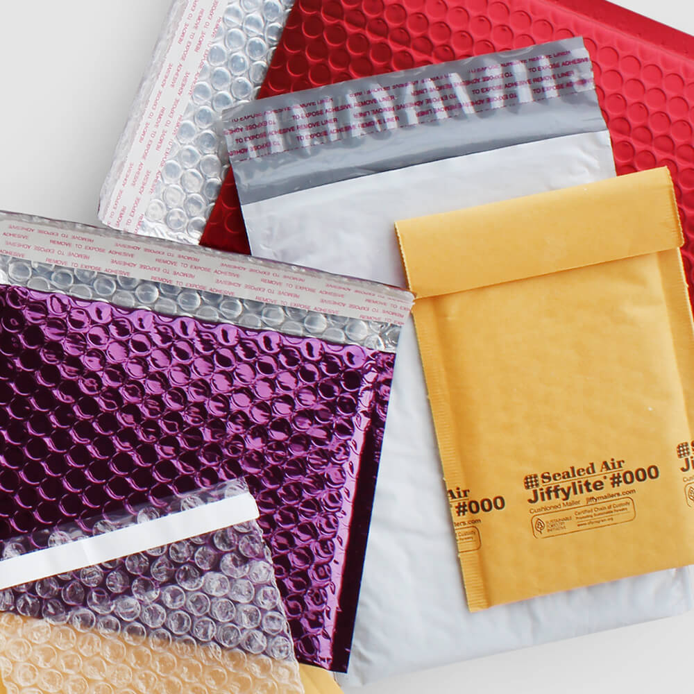 A flat lay photo of Paper Mart Bubble Mailers, Metallic Bubble Mailers, and Self-Sealing Bubble Bags