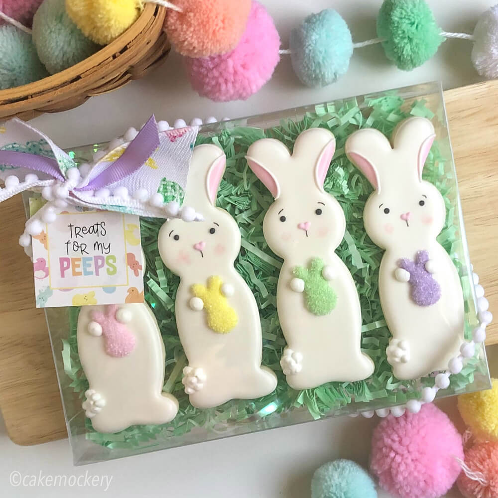 Decorated Easter cookies made by Cake Mockery packaged in Paper Mart plastic boxes and ribbon