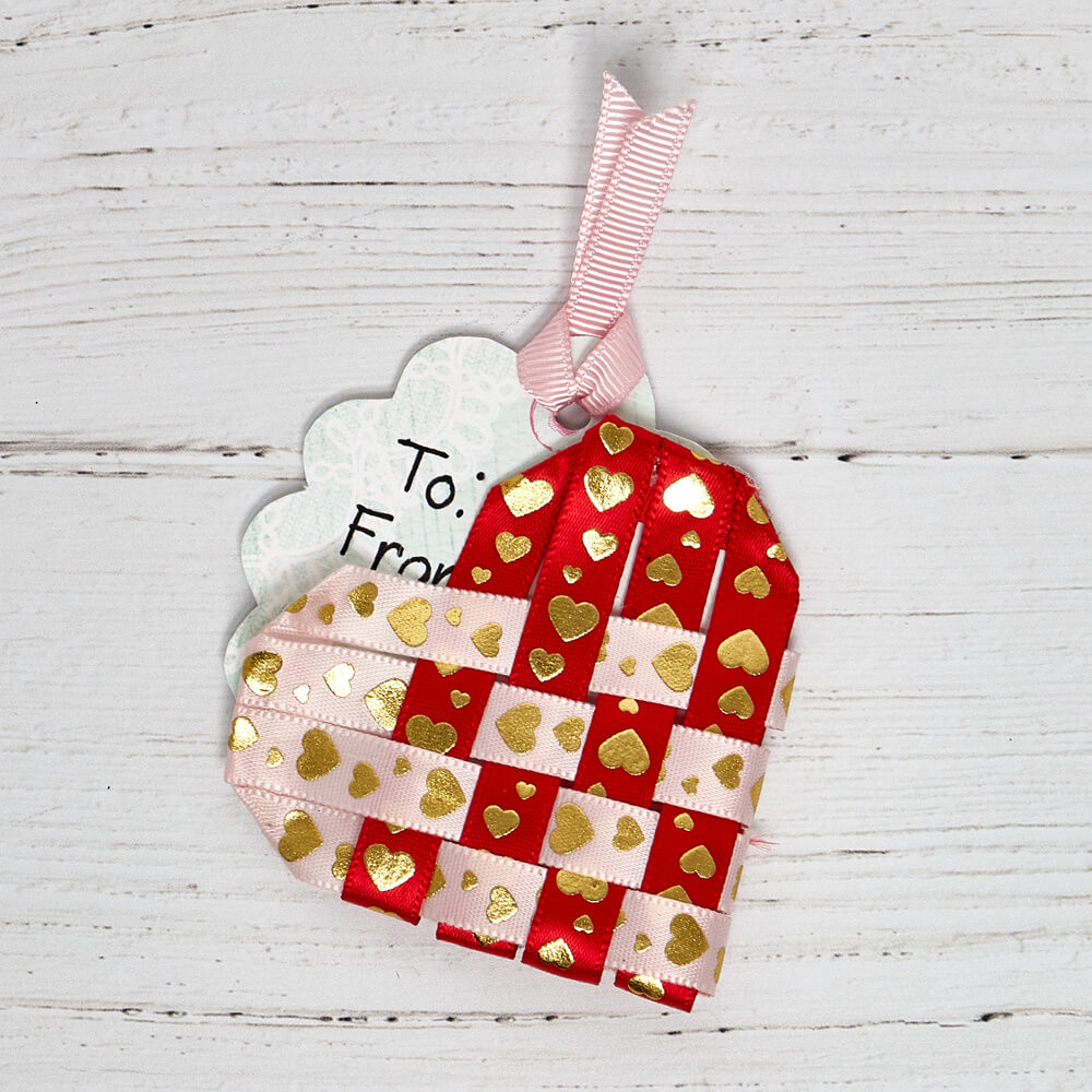 gift tag with a woven DIY ribbon embellishment on top of it