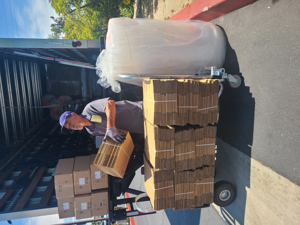 Paper Mart Delivery Service Driver loading boxes