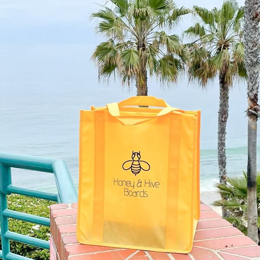 Honey & Hive Boards showcasing Paper Mart's custom yellow canvas tote shopping bags